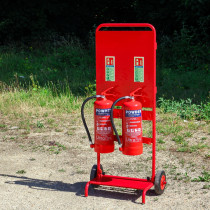 Fmctf7 Fmc Site Trolley with two red powder extinguishers mounted on a red wheeled trolley outdoors