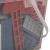 Close up of plastic fire door packer strips in red, grey, and blue stacked inside a clear container with a white handle