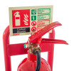 Close-up of red metal extinguisher stand handle with safety instruction label showing carbon dioxide details