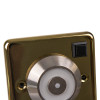 a close up of the manual release button on the brass decorative door holder