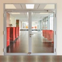 geze ts5000ism guide rail installed on double glass doors in a modern office building