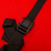Black safety buckle attached to strap on evac e pad with bag against red background