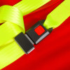 Buckle on hospital aids ski pad and storage bag with yellow straps and red press button on a red background