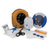 A blue and white defibrillator with a yellow storage bag, defibrillator pads and a prep kit