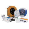 A blue and white defibrillator with a yellow storage bag, defibrillator pads and a prep kit