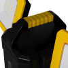 Close up of the yellow handle on a rechargeable led site light with black body and yellow panels