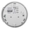 Close-up of the back of a HiSPEC wireless smoke alarm showing model number HSSA/PF/10-PRO, technical specifications, safety warnings, and certification marks. Includes installation arrow and battery replacement date.