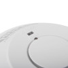 Close-up of a fire and carbon monoxide detector showing labeled indicators for “AC POWER” and “ALARM,” with a small window and circular opening likely for LED status lights.