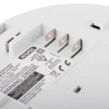 Rear view of a HiSPEC smoke alarm model HSA/BF/10-PRO with three metal prongs, battery details, safety warnings, and certification standards printed on the label.