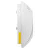 Side view of a white wall-mounted smoke detector showing curved front, mounting pegs, and a yellow label with red text instructing how to release the unit.
