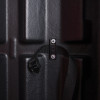 Close up of internal securing strap inside double extinguisher cabinet showing black buckle and textured surface