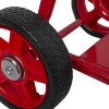 Close-up of a black rubber wheel on the red frame of the double extinguisher trolley bucket bracket