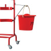 Red fire bucket hanging on a fire bucket bracket attached to a red metal frame with wheels