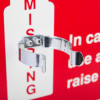 Close up of the bracket attached to the emergency air horn sign with part of the red and white sign visible