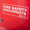Close up of the front of a red metal document cabinet key lock showing a FIRE SAFETY DOCUMENTS label and a lock mechanism