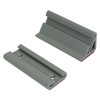 Two grey triangular mounting brackets with grooves on top and red adhesive pads on the base, one with screw holes