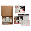 Open Firechief Kitchen Stove Guard box with the device, components, and printed installation materials laid out on a surface
