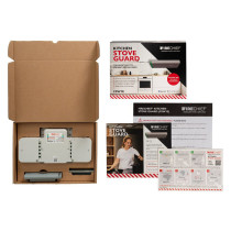 Open Firechief Kitchen Stove Guard box with the device, components, and printed installation materials laid out on a surface