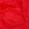Closeup of red fabric material of wheeled fire extinguisher cover 100kg showing texture and stitching details