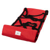 Unrolled evacuation sledge with wall mounted storage bag showing red fabric and black straps laid flat