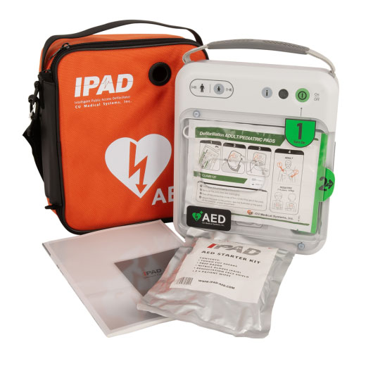 A white defibrillator next to a bright orange carry case
