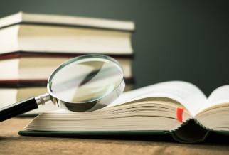A magnifying glass with an open reference book