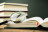 A magnifying glass with an open reference book