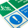 Close up of an emergency evacuation chair sign made of rigid plastic showing green and blue safety symbols