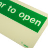 Close up of a push bar to open sign made of rigid plastic showing part of the green and white lettering