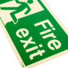 Close up of fire exit sign rigid plastic down left size k showing white text and figure on green background