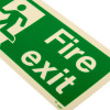 Close up of a fire exit sign rigid plastic up left size t showing the running man symbol and text Fire Exit in green and white