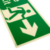 close up of a fire exit sign rigid plastic right size j showing a green background with a running figure and arrow pointing right