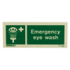 emergency eye wash sign in green with white text and a graphic of an eye being rinsed shown from the front