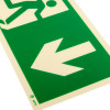 close up of a green and white fire exit sign rigid plastic down size k showing a white arrow pointing down left