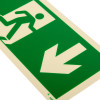 Close up of fire exit sign rigid plastic down size t showing a white running figure and downward arrow on a green background