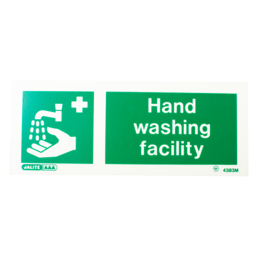 green hand wash facility sign with text on rigid plastic showing faucet pouring water on hand viewed from front