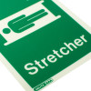 Close up of stretcher location sign with text on rigid plastic angled surface showing a person on a stretcher
