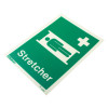 Angled view of a stretcher location sign with text printed on rigid plastic showing a person lying on a stretcher and a cross symbol