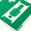 Close up of stretcher location sign rigid plastic showing white figure on green background