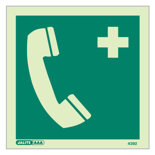 emergency telephone sign showing a pale telephone handset and medical cross on green background front view