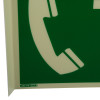 Closeup of the emergency telephone panoramic sign showing part of a white telephone symbol on a green background