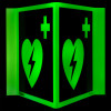 panoramic aed wall sign glowing green with heart and lightning bolt symbols on two connected panels