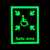 safe area sign rigid plastic showing a green wheelchair symbol with arrows pointing inward on a dark background