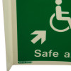Closeup of safe area panoramic sign showing part of a white wheelchair symbol and an arrow on a green background