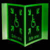 safe area panoramic sign showing glowing green wheelchair symbol with arrows pointing inward on two angled panels