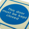 Closeup of Js5067A Jalite This Door Must Be Kept Closed vinyl sign with blue circle and white text