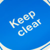 Close up of keep clear sign vinyl with white text on a blue background
