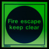 Glowing fire escape keep clear sign with green lettering on a black circle background and a green square border