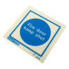 Angled image of fire door keep shut sign vinyl with blue circle and white text on white background