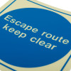Closeup of Js5485Er Jalite rigid plastic escape route keep clear mandatory sign showing white text on blue background